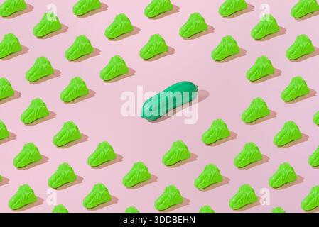 Creative abstract summer salad and cucumber pattern flat lay on pastel pink background minimalism Stock Photo