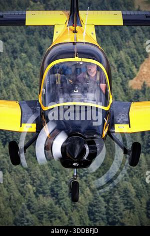 A Scottish Aviation Bulldog 120/125A, registered C-FHEE, serial number BH120/415 and other marks 415, is captured from a close-up pilot perspective during the Abbotsford International Airshow in Canada in 2025. The aircraft displays Royal Air Force training colors. This two-seat, single-engine, low-wing military trainer shows cockpit instruments, pilot controls, fixed tricycle landing gear, tail, wings, and control surfaces. The image highlights operational features and flight handling of a restored, airworthy trainer. Stock Photo