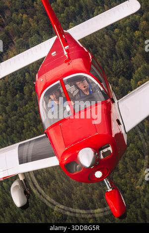 The Piper PA-28-140 Cherokee, C-FXKP, MSN 28-22195, is captured in close-up pilot view during air-to-air flight at the Abbotsford International Airshow, Canada 2025. This two-seat, single-engine aircraft has a low-wing design, fixed landing gear, and all-metal fuselage. It is known for stable handling, reliability, and suitability for training and recreational aviation. Stock Photo