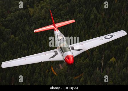 The North American P-51D Mustang, registration NL551D, serial number 1364, is captured in a close-up air-to-air view showing the pilot in the cockpit during the 2025 Abbotsford International Airshow in Canada. This demonstration highlights the aircraft’s operational cockpit layout, instrumentation, and pilot visibility, providing insight into the handling and control characteristics of this historic World War II fighter aircraft. Stock Photo