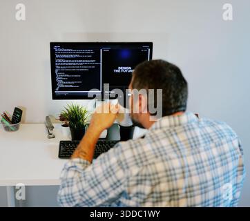 Middle Aged Software Engineer Vibe Codes Landing Page for Artificial Intelligence Based Integrated Development Environment Application Concept Stock Photo