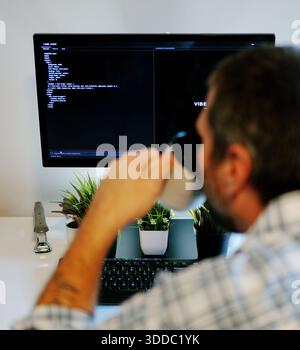 Middle Aged Software Engineer Vibe Codes Landing Page for Artificial Intelligence Based Integrated Development Environment Application Concept Stock Photo