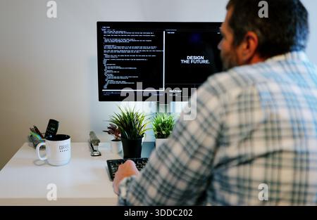 Middle Aged Software Engineer Vibe Codes Landing Page for Artificial Intelligence Based Integrated Development Environment Application Concept Stock Photo