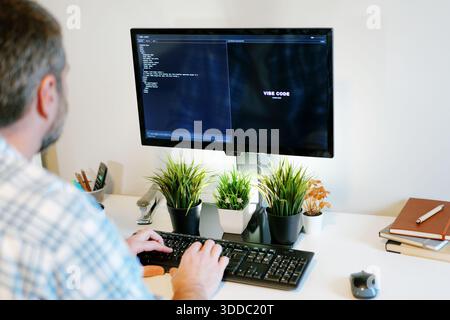 Middle Aged Software Engineer Vibe Codes Landing Page for Artificial Intelligence Based Integrated Development Environment Application Concept Stock Photo