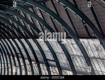 London, UK - May 13, 2025 - Architecture greco-roman style with iron glass roof and light bulbs on the ceiling in Covent Garden Market Hall. View of M Stock Photo