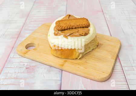 Cinnamon rolls shaped like a ring, where the ends are joined to form a circle, baked in a round pan and topped with vanilla glaze Stock Photo