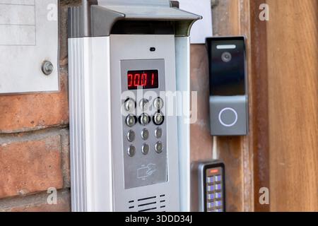 Modern intercom system with a digital keypad and camera providing secure entry control for a residential or commercial building Stock Photo