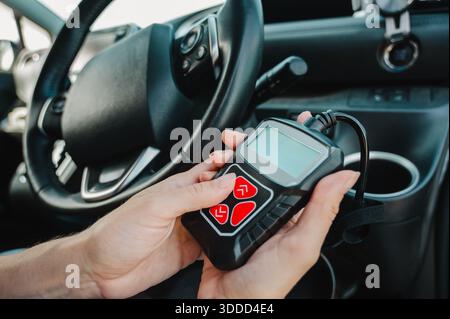 Woman using OBD2 diagnostic scanner.  Stock Photo