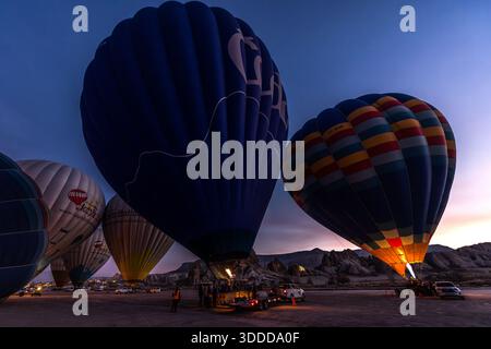Hot air balloons are inflated before sunrise in Göreme, Central Anatolia Region, Turkey Stock Photo