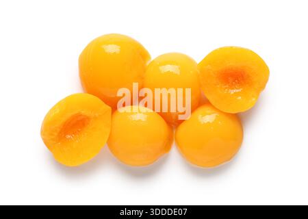 Sweet canned peaches on white background Stock Photo