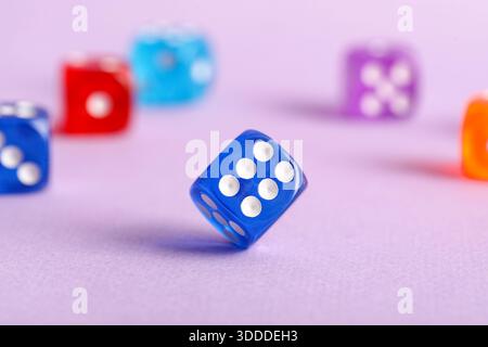 Colorful game dices on lilac background, closeup Stock Photo