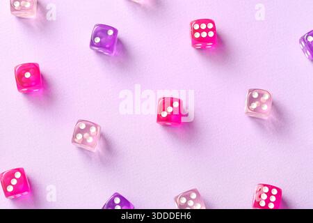 Different game dices on lilac background Stock Photo