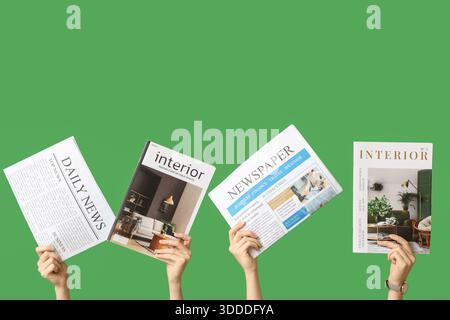 Female hands with different magazines and newspapers on green background Stock Photo
