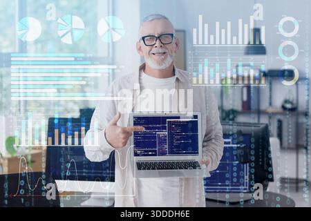 Double exposure of mature data science with laptop in office and virtual screen with statistics Stock Photo