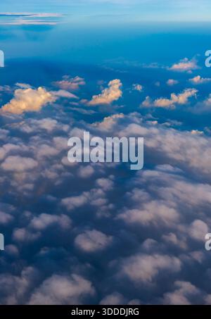 Aerial view of monsoon clouds over the plains of India, at dawn. Thick layers of Cumulonimbus and Cumulus clouds are visible in the frame. Stock Photo