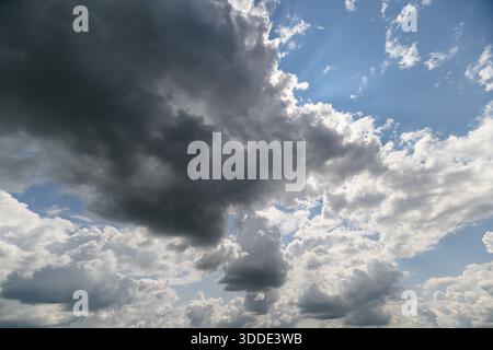 A breathtaking and stunning view showcasing the contrast between dark and light clouds in a bright blue sky Stock Photo