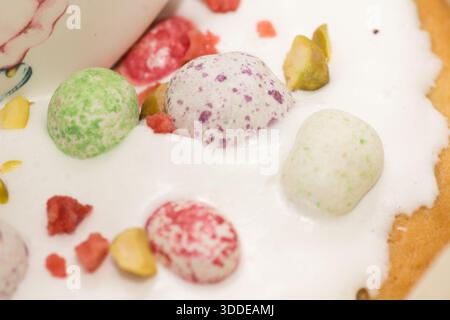 Traditional Easter dinner or brunch with ham, colored eggs, hot cross buns, cake and vegetables. Easter meal dishes with holday decorations. Stock Photo