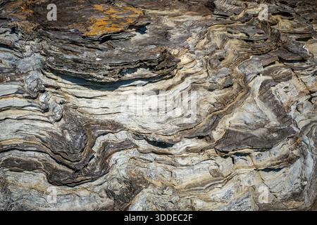 Brown stone or rock background and texture, abstract background of rocky formation with uneven texture, natural rock layers showing intricate geologic Stock Photo