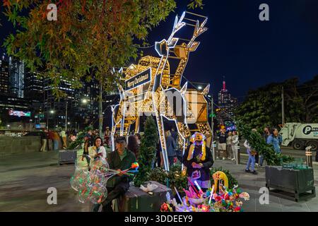Vendor selling illuminated Christmas toys  at night on the southbank, Melbourne, Australia on 16 December 2025 Stock Photo