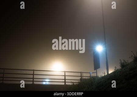 A spooky road, on an eerie mysterious foggy winters night in a city, Worcester UK Stock Photo