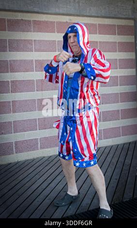 A retired 70 year old boxer in a stars & stripes robe poses in Coney Island at the annual Polar Bear New Years Day swim. Stock Photo