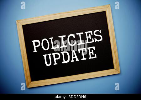 Policies Update text written on chalkboard flat lay on blue background Stock Photo