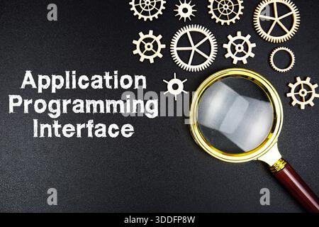 Application Programming Interface text message with magnifying glass on black background Stock Photo