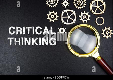 Critical Thinking text message with magnifying glass on black background Stock Photo