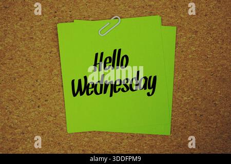 Hello Wednesday text written on sticky note  on wooden cork  background Stock Photo