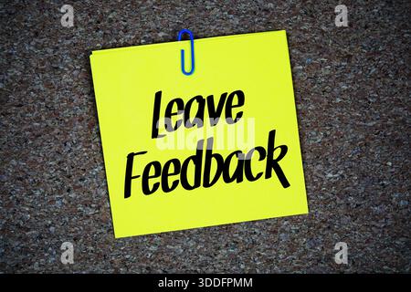 Leave Feedback text written on sticky note  on blue  background Stock Photo