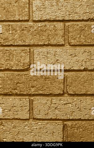 Brick wall background backdrop painted with metallic gold coloured paint. Interior design concept. Stock Photo