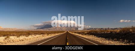 Long Road Leading To Guadalupe Mountains And The Large Cloud Covering it in Winter Stock Photo