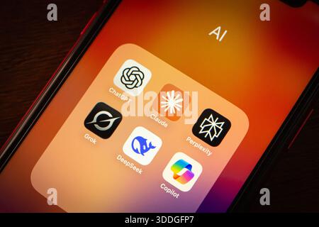 Close-up of a smartphone folder showing popular AI chatbot apps including ChatGPT, Claude, Grok, Copilot, Perplexity, and DeepSeek. Stock Photo