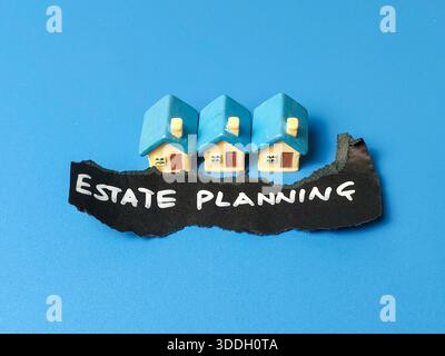 Estate Planning Sign with Small Toy Houses on Blue Background for Real Estate Law Inheritance and Financial Wealth Management Concept Stock Photo