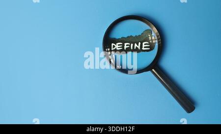 Magnifying Glass Focusing on Define Sign on Blue Background for Brand Identity Discovery Strategic Analysis and Business Project Scoping Concept Stock Photo