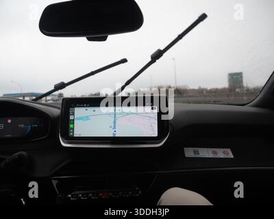 A GPS navigation system in a car displaying a map on its screen, providing directions and guidance for a safe and convenient journey. Vicenza, Italy - Stock Photo