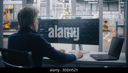 Experienced Manager Performs Remote Maintenance and Diagnosis of Industrial Equipment Using Dual Screen Workstation in Modern Data Center. Concept of Predictive Maintenance and Expert Control. Stock Photo
