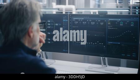 Data Scientist Wearing Glasses, Analyzing Cloud System Performance Graphs and Data Flow on Two Large Monitors in Modern, Controlled Server Environment. Concept of Cloud Engineering and Data Science. Stock Photo