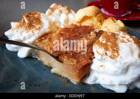 szarlotka traditional polish apple pie covered in cinnamon with cream and ice cream gdansk poland Stock Photo