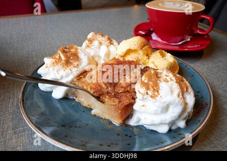szarlotka traditional polish apple pie covered in cinnamon with cream and ice cream and coffee gdansk poland Stock Photo