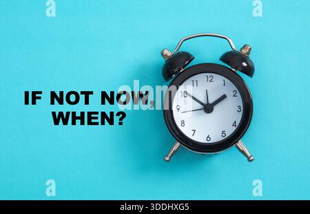 Alarm clock reminding of time management and motivating action on a blue background Stock Photo