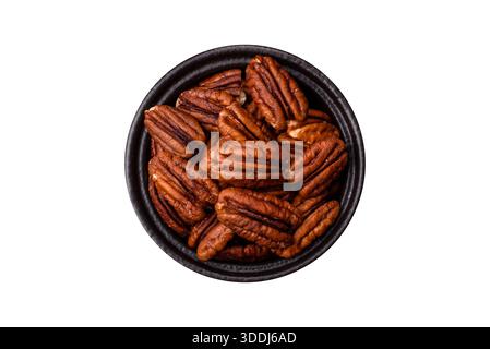 Peeled and roasted pecan nut as an ingredient for healthy foods and snacks. Pecan nut as a food background for your design. Stock Photo