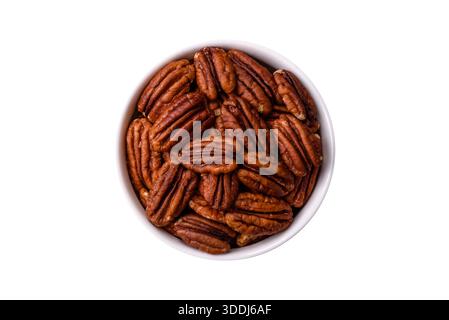Peeled and roasted pecan nut as an ingredient for healthy foods and snacks. Pecan nut as a food background for your design. Stock Photo