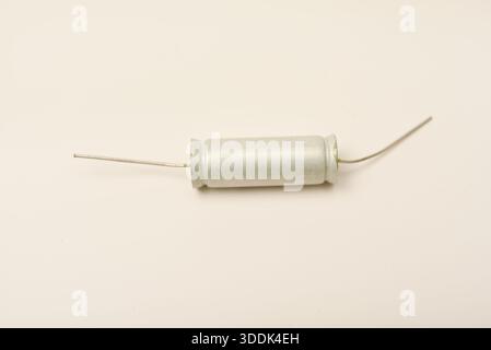 Old capacitors in paper packaging. Aluminum capacitors on a white background. Electronic components. Stock Photo