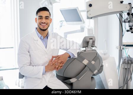 Dental Services. Portrait Of Professional Arab Stomatologist Doctor Posing At Workplace Stock Photo