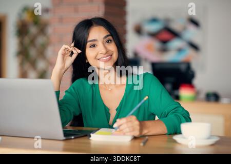 Beautiful indian woman freelancer working at cafe Stock Photo
