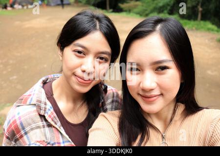 Two Young Beautiful Asian Woman Selfie at an Outdoor Camping Ground Stock Photo