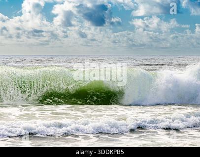detail of a crashing wave on a montauk beach on a summer day Stock Photo