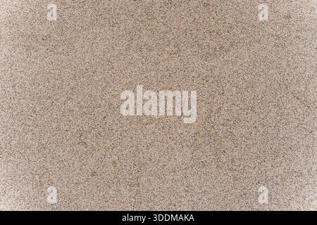 Brown and grey speckled granular surface texture, rough weathered concrete or stone backdrop ideal for seamless patterns, textured design elements and Stock Photo