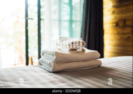 Folded Towels on Bed in Cozy Hotel Room, Koh Man, Thailand Stock Photo